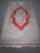 A fringed Persian design rug