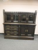 A late Victorian oak side cabinet with glazed top,