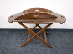 A mahogany butlers tray on stand