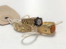 Three yellow metal dress rings, indistinctly marked.