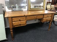 A pine writing desk fitted five drawers