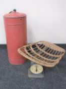 A set of baby weighing scales and a lidded urn
