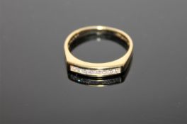 An 18ct gold ring, channel set with eight princess cut diamonds,
