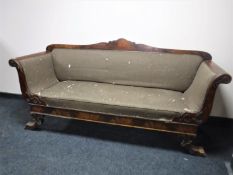 A Victorian mahogany scroll arm settee on paw feet