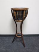 A bentwood plant stand with metal insert