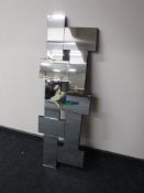 A contemporary all glass sectional mirror