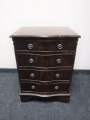 A Georgian style mahogany serpentine fronted four drawer chest