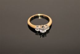A 14ct gold three stone diamond ring, the total diamond weight estimated at 0.