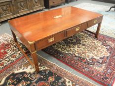 A mahogany brass mounted military low table fitted with three drawers,