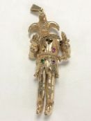 A yellow metal pendant modelled as a jester set with gemstones, 41.4g.