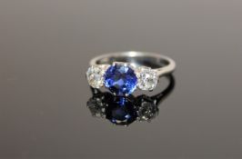 A fine quality diamond and sapphire three stone ring, a pale blue,