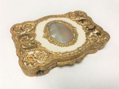 An ornate Italian gilt snuff box with mother of pearl inlay