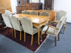 A ten piece walnut dining room suite comprising of serpentine fronted sideboard,