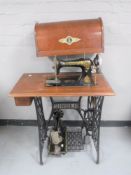 A Singer treadle sewing machine in mahogany table,