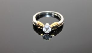 A platinum diamond solitaire ring, the brilliant cut stone weighing an estimated 0.