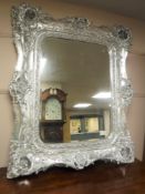 An ornate silvered framed mirror,