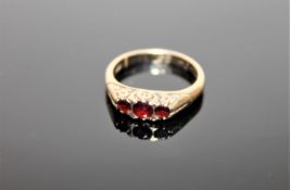 A 9ct gold three stone garnet ring,