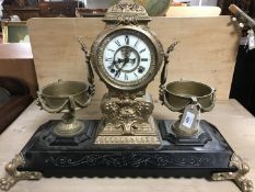 A nineteenth century ornate cast metal clock garniture,