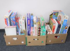 Three boxes containing assorted board games together with a Subbuteo table soccer set