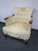A Victorian mahogany armchair upholstered in a gold button fabric