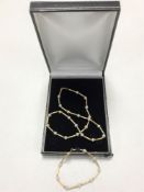 A 9ct gold necklace and matching bracelet set with small pearls, 16.4g.