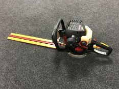 A Homelite Mightylite petrol hedge cutter