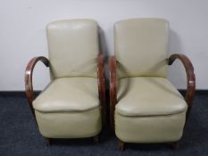 A pair of mid twentieth century vinyl upholstered armchairs