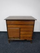 A mid twentieth century shutter door cupboard fitted three drawers