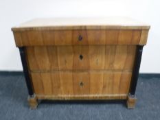 A walnut three drawer Art Deco chest with column supports