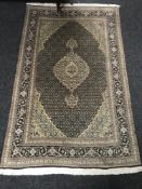 A Tabriz design rug CONDITION REPORT: 166cm by 100cm. In good condition.