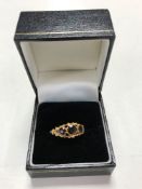 A 9ct gold three stone garnet ring, size N/O.