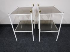 A pair of mid twentieth century metal and smoked glass two tier side tables
