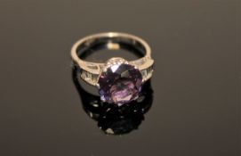 An 18ct white gold Alexandrite ring, a brilliant cut Alexandrite within a claw setting,