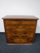 A late nineteenth century walnut four drawer chest