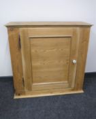 An antique pine wall cabinet