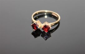 A 9ct gold two-stone garnet ring,