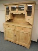 An early 20th century pine kitchen dresser,