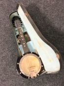 A mandolin-banjo in case, the head stamped 'Reliance No.