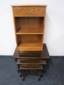 A nest of three oak tables together with a small oak bookshelf fitted a drawer