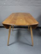 An Ercol elm drop leaf table