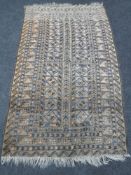 A fringed Afghan rug