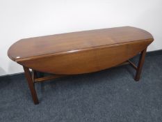 A narrow mahogany drop leaf coffee table