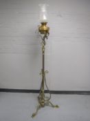 A Victorian brass rise and fall standard oil lamp