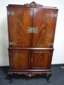 A mahogany Queen Anne style double door cocktail cabinet