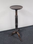 A mahogany torchere on three way support