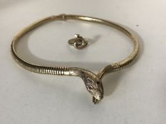 A 9ct gold snake necklace with ruby eyes, 27.1g gross, together with a matching 9ct gold snake ring.