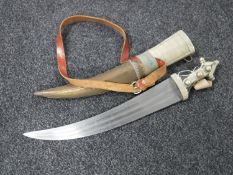 A curved Persian short sword in metal sheath