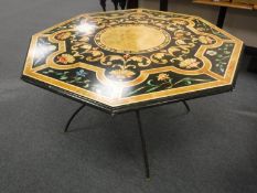 A contemporary octagonal dining table on an iron base