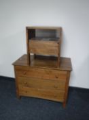 A three drawer chest in a teak finish together with a similar bedside stand