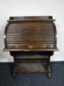 An early 20th century oak roll front bureau